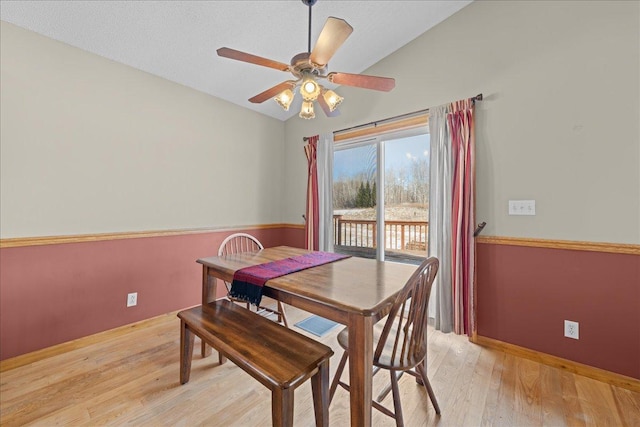 dining room with vaulted ceiling, ceiling fan, and light hardwood / wood-style flooring