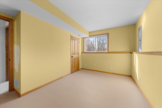 spare room featuring light colored carpet