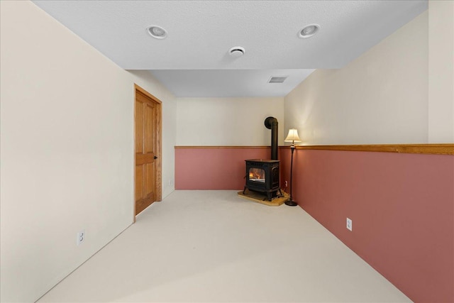 corridor with carpet flooring and a textured ceiling