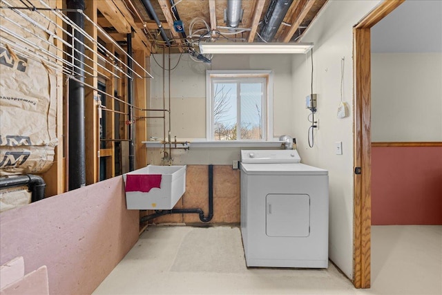 clothes washing area featuring washer / clothes dryer and sink