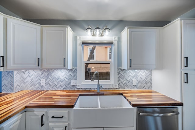 kitchen featuring wood counters, sink, and white cabinetry