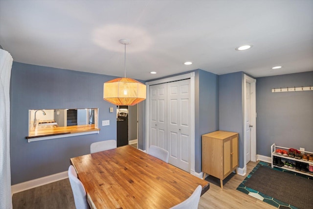 dining space with wood-type flooring