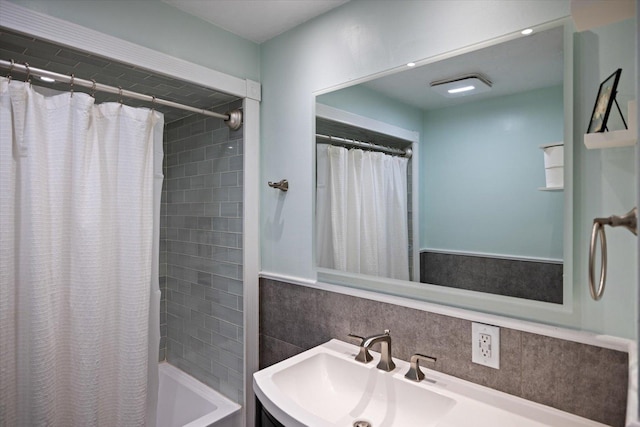 bathroom with vanity, shower / tub combo, and backsplash