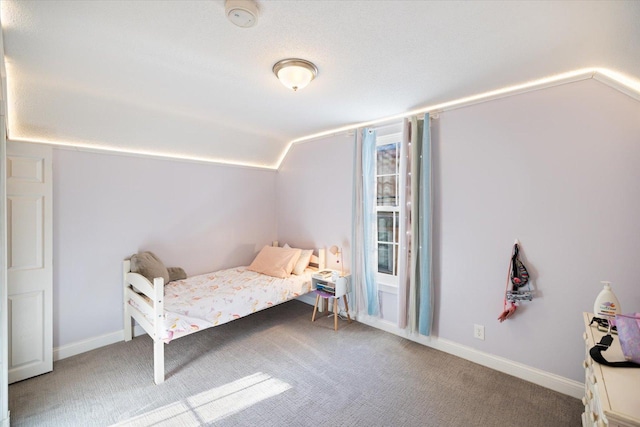 bedroom featuring lofted ceiling and carpet flooring