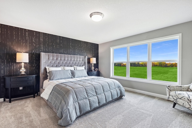 bedroom featuring multiple windows and carpet flooring