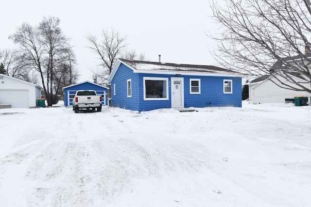 view of front facade with a garage and an outdoor structure