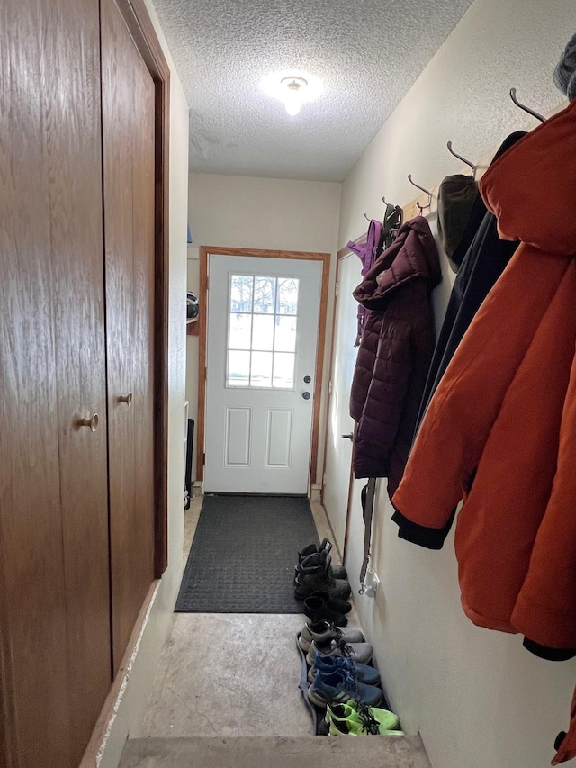 mudroom featuring a textured ceiling