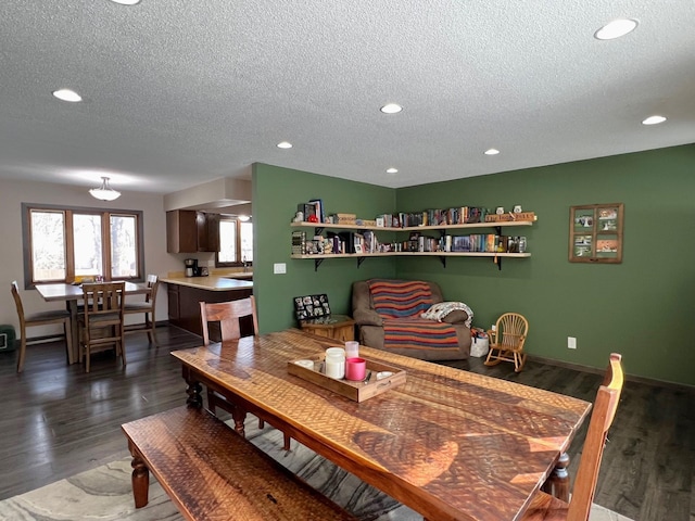 dining space featuring recessed lighting, baseboards, dark wood-type flooring, and a textured ceiling