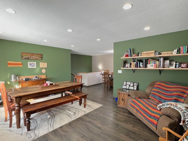 dining space featuring recessed lighting, a textured ceiling, and wood finished floors