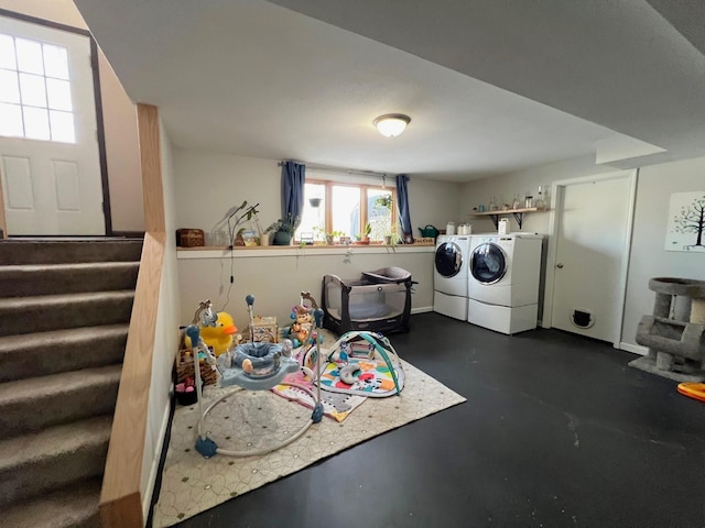 clothes washing area featuring washer and clothes dryer and laundry area