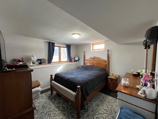 bedroom with multiple windows and a textured ceiling