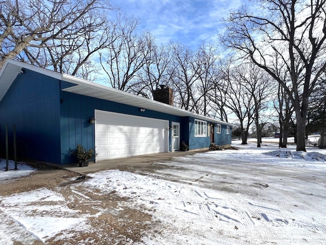 exterior space with an attached garage and a chimney