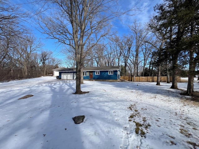 view of front of house featuring a garage and fence