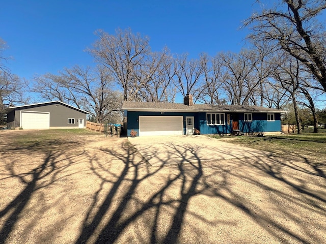 5260 111th Ave NE, Spicer, MN 56288 - view of front of property featuring fence, a chimney, an attached garage, and aphalt driveway