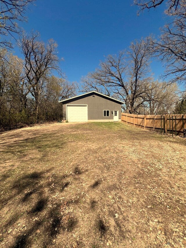 5260 111th Ave NE, Spicer, MN 56288 - view of yard with an outdoor structure, fence, and a detached garage