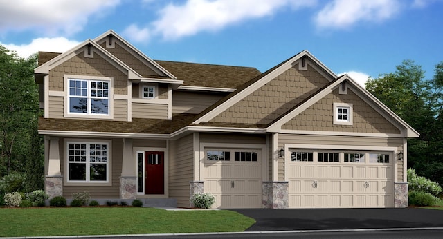 craftsman-style house featuring a garage and a front lawn