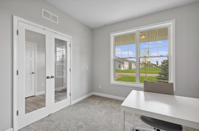 unfurnished office with light carpet and french doors