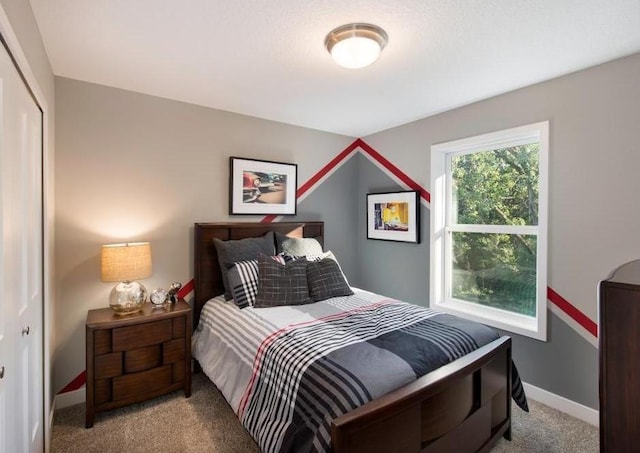 bedroom featuring light carpet and a closet