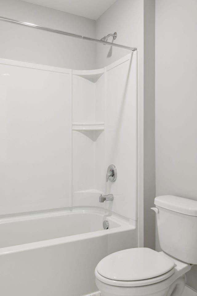 bathroom featuring shower / washtub combination and toilet