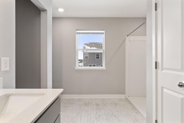 bathroom featuring vanity and a shower