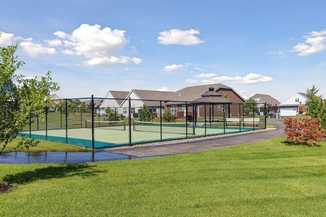 view of property's community featuring a gazebo, tennis court, and a lawn