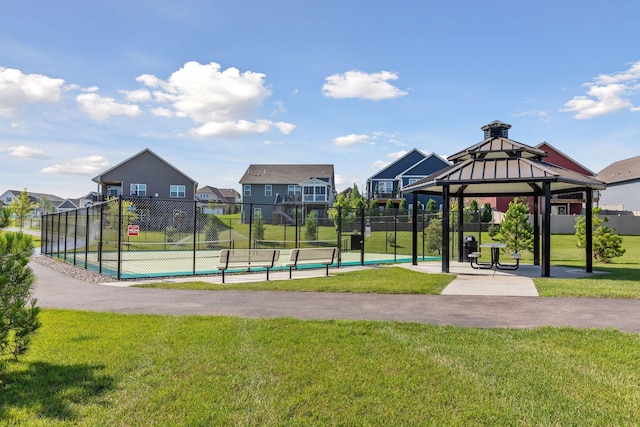 surrounding community with a gazebo, tennis court, and a lawn