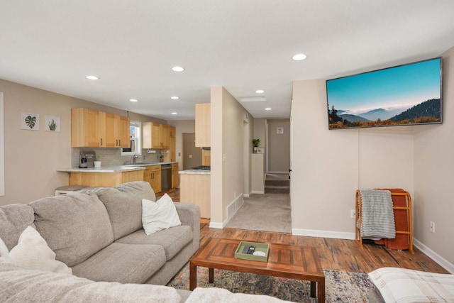 living room featuring light wood-style floors, baseboards, and recessed lighting