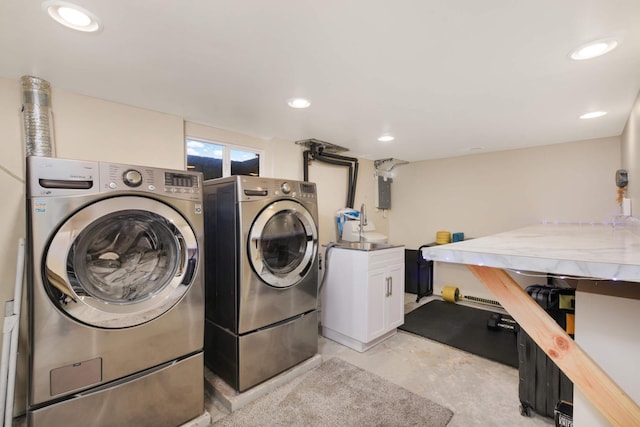 laundry room featuring recessed lighting, cabinet space, and washer and dryer