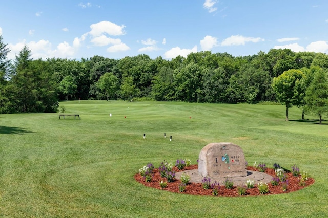 view of property's community with a lawn and golf course view