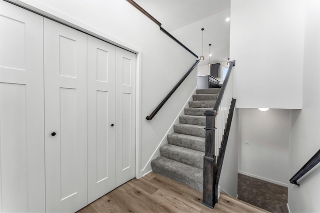 stairs featuring wood-type flooring