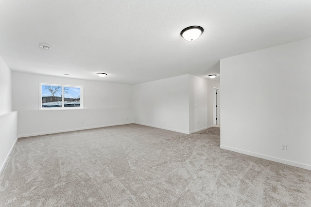 unfurnished room featuring light colored carpet