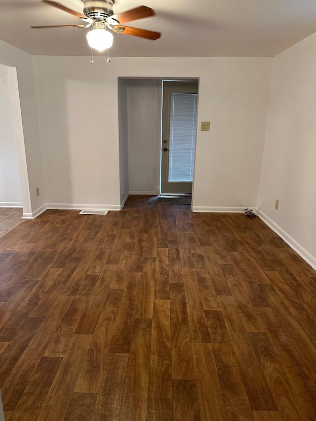 unfurnished room with ceiling fan and dark hardwood / wood-style floors