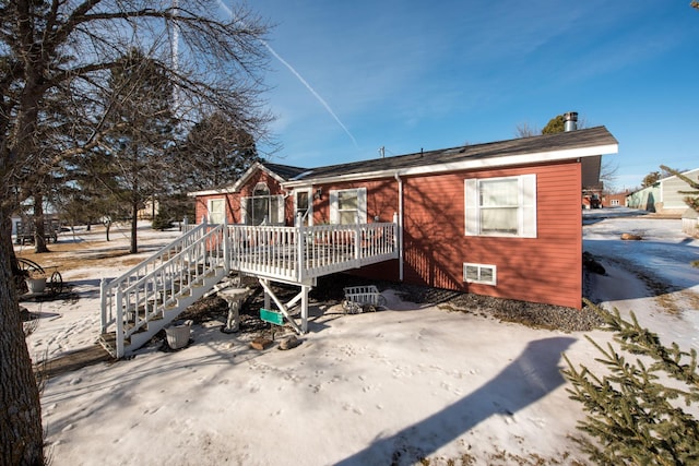 rear view of house featuring a wooden deck