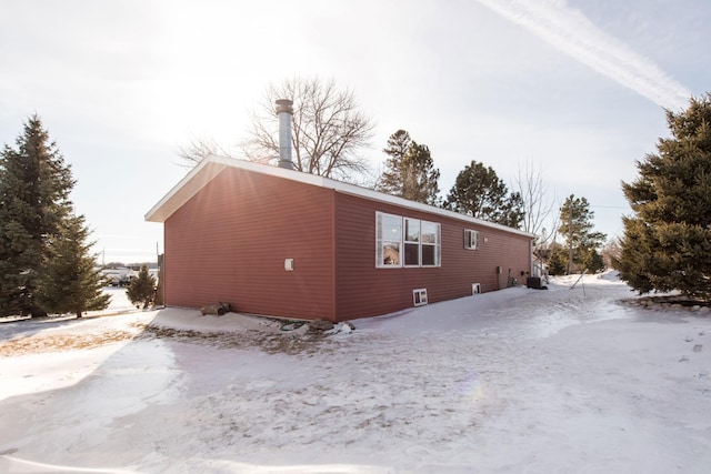 view of snowy exterior featuring central AC unit