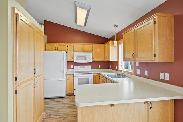 kitchen with pendant lighting, sink, white appliances, vaulted ceiling, and kitchen peninsula