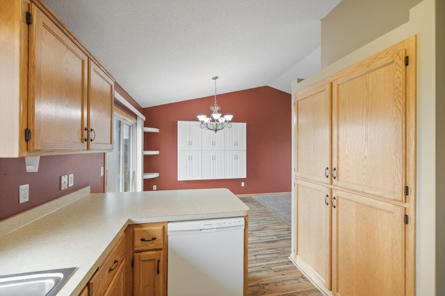 kitchen with lofted ceiling, light hardwood / wood-style flooring, hanging light fixtures, white dishwasher, and a notable chandelier