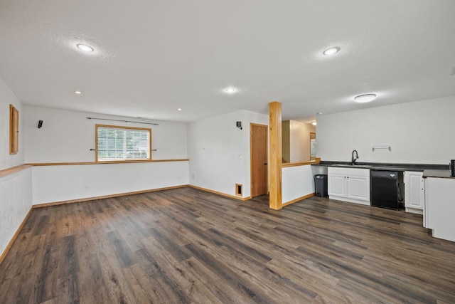 kitchen featuring dark wood-type flooring, sink, refrigerator, black dishwasher, and white cabinets