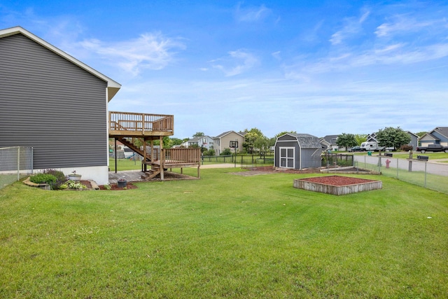 view of yard with a deck and a storage unit