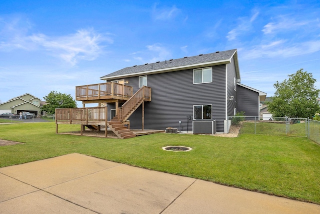 back of house featuring a wooden deck, a yard, a patio, and a fire pit