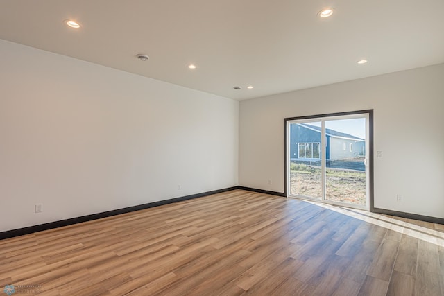 empty room with light hardwood / wood-style flooring