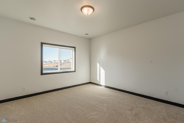 empty room featuring light colored carpet