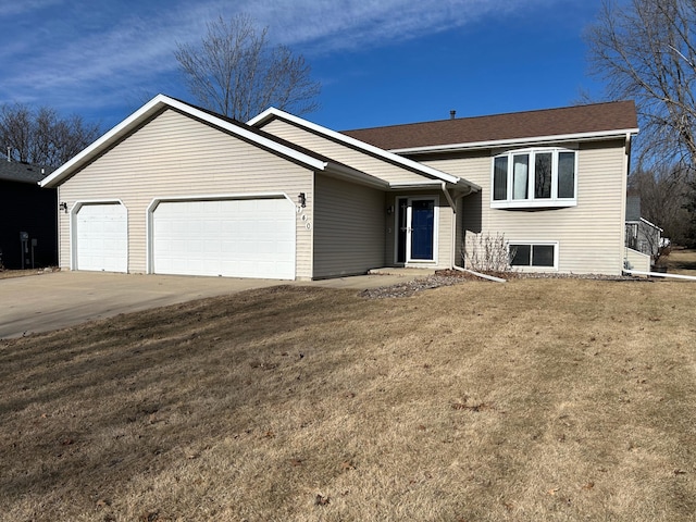 view of front of house with a garage and a front lawn