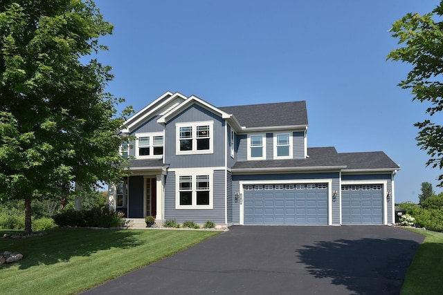 view of front of house with a garage and a front yard