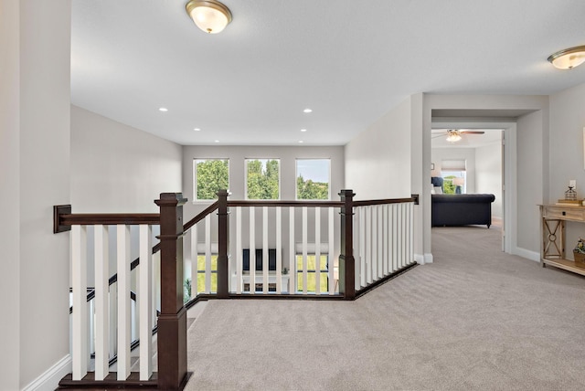 hallway with light colored carpet