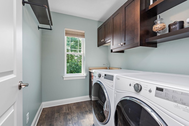 clothes washing area featuring cabinets, dark wood-type flooring, sink, and washer and clothes dryer