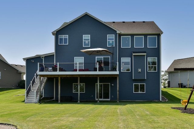 back of property featuring a wooden deck and a lawn