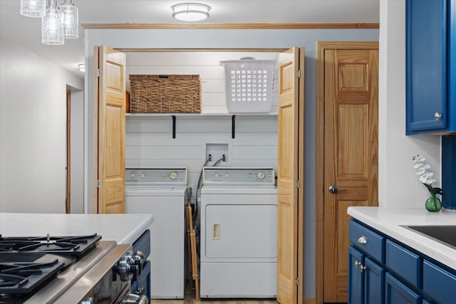 clothes washing area featuring ornamental molding and independent washer and dryer