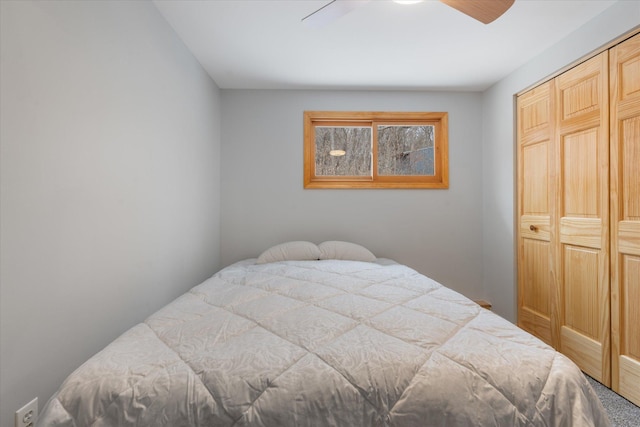 bedroom with ceiling fan and a closet