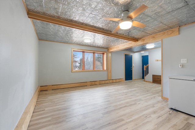 unfurnished living room featuring ceiling fan, a baseboard radiator, and light wood-type flooring