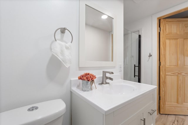 bathroom featuring hardwood / wood-style flooring, vanity, and toilet